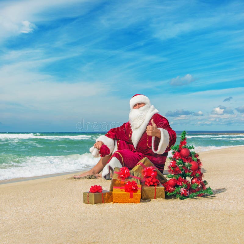 santa-claus-sea-beach-many-gifts-decorated-christmas-tree-happy-new-year-concept-36141748.jpg